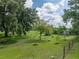 Expansive backyard features mature trees, lush lawn, and a garden area that enhances the serene outdoor space at 2802 Midway Rd, Plant City, FL 33565