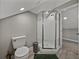 This bathroom features a glass-enclosed shower, toilet, and stylish fixtures for a functional and modern space at 2802 Midway Rd, Plant City, FL 33565