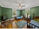 Comfortable bedroom features a hardwood floor and warm-toned green walls, offering a cozy and inviting atmosphere at 2802 Midway Rd, Plant City, FL 33565