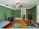 Comfortable bedroom features a hardwood floor and warm-toned green walls, offering a cozy and inviting atmosphere at 2802 Midway Rd, Plant City, FL 33565