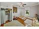Charming bedroom with wood floors, decorative fireplace, and closet featuring a curtain at 2802 Midway Rd, Plant City, FL 33565