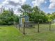 Fenced chicken coop with green house, perfectly integrated into the surrounding lush landscape at 2802 Midway Rd, Plant City, FL 33565