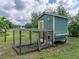 Well-maintained green chicken coop with outdoor run, ideal for hobby farmers or animal lovers at 2802 Midway Rd, Plant City, FL 33565