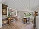 Charming dining area with wood floors, a rustic table, and views to the kitchen at 2802 Midway Rd, Plant City, FL 33565
