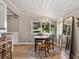 Sunlit dining room with a wood table, mirror, and view into the kitchen at 2802 Midway Rd, Plant City, FL 33565