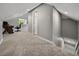 Upstairs hallway featuring carpeted floors, access to rooms, and dormer windows at 2802 Midway Rd, Plant City, FL 33565