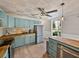 Bright and airy kitchen features updated appliances, light blue cabinets, and butcher block countertops at 2802 Midway Rd, Plant City, FL 33565