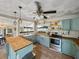 Well-lit kitchen features custom cabinets, butcher block countertops, and stainless steel appliances at 2802 Midway Rd, Plant City, FL 33565