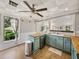 Bright kitchen featuring blue cabinets, butcher block countertops, and stainless steel appliances at 2802 Midway Rd, Plant City, FL 33565