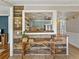 Charming rustic wood table with a pass-through view into a bright, updated kitchen at 2802 Midway Rd, Plant City, FL 33565