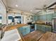 Open kitchen featuring blue cabinets, butcher block countertops, and stainless steel appliances at 2802 Midway Rd, Plant City, FL 33565