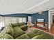 Inviting living room with a large, comfortable green sectional sofa and stylish decor at 2802 Midway Rd, Plant City, FL 33565