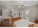 Serene bedroom featuring wood floors, fan, and multiple doorways with views of other spaces at 2802 Midway Rd, Plant City, FL 33565