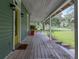 Inviting porch featuring yellow front door and view of the surrounding greenery at 2802 Midway Rd, Plant City, FL 33565