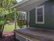 Charming front porch with a wooden swing and beautiful landscaping creates an inviting entryway to this home at 2802 Midway Rd, Plant City, FL 33565