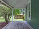 Inviting porch with a relaxing swing and view of the serene surroundings at 2802 Midway Rd, Plant City, FL 33565