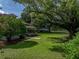 Expansive yard with a large shade tree and view of home's porch at 2802 Midway Rd, Plant City, FL 33565