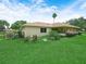 The house features a beautiful green lawn and a cozy screened-in patio for outdoor enjoyment at 2815 Kebs Ln, Plant City, FL 33565