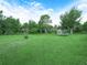 Lush green backyard featuring mature trees, well-maintained lawn, and plenty of open space at 2815 Kebs Ln, Plant City, FL 33565