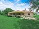 Exterior shot of a lovely home with a screened-in patio, lush green lawn, and manicured landscaping at 2815 Kebs Ln, Plant City, FL 33565