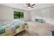 Bright bedroom featuring a ceiling fan, plush carpet, and a large window at 2815 Kebs Ln, Plant City, FL 33565