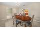 Cozy dining room adjacent to living spaces, with a classic chandelier and backyard view at 2815 Kebs Ln, Plant City, FL 33565