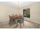 Charming dining room with wooden table, chandelier, and window overlooking the backyard at 2815 Kebs Ln, Plant City, FL 33565