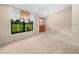 Bright entryway with tile and carpet flooring, light-colored walls, and large windows overlooking a landscaped lawn at 2815 Kebs Ln, Plant City, FL 33565