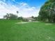 Spacious front yard featuring a well-maintained lawn, mature trees, and a circular driveway at 2815 Kebs Ln, Plant City, FL 33565