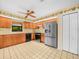 Bright and functional kitchen featuring wood cabinets, stainless steel refrigerator and black appliances at 2815 Kebs Ln, Plant City, FL 33565