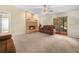 Cozy living room with a brick fireplace, carpeted floors, and double glass doors to outdoor area at 2815 Kebs Ln, Plant City, FL 33565
