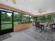 Relaxing screened patio with outdoor dining set and serene backyard views at 2815 Kebs Ln, Plant City, FL 33565