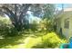 Lush backyard featuring a stone path, mature trees, and well-maintained lawn at 4718 Crystal Ave, Sarasota, FL 34231