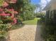Well-maintained backyard with vibrant flowers, a stone pathway, and a meticulously kept lawn at 4718 Crystal Ave, Sarasota, FL 34231