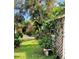 Private backyard featuring lush greenery, colorful flowers, and a charming fence, for serene outdoor living at 4718 Crystal Ave, Sarasota, FL 34231