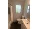 Well-lit bathroom featuring patterned wallpaper, modern fixtures, and a shower with curtain at 4718 Crystal Ave, Sarasota, FL 34231