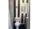 Charming bathroom with black and white striped accent wall, modern vanity, and tiled shower at 4718 Crystal Ave, Sarasota, FL 34231