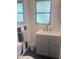 Cozy bathroom featuring modern vanity, subway tile, and charming black and white accent wall at 4718 Crystal Ave, Sarasota, FL 34231