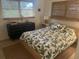 Serene bedroom with leaf-patterned bedding, wooden nightstands, and woven window shades for a calming ambiance at 4718 Crystal Ave, Sarasota, FL 34231