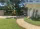 The home's driveway and landscaping, which includes a rock path and vibrant plants, add to the curb appeal at 4718 Crystal Ave, Sarasota, FL 34231