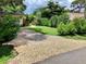 Beautifully landscaped front yard with a driveway, lush grass, and mature trees at 4718 Crystal Ave, Sarasota, FL 34231