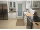 Well-lit kitchen featuring stainless steel appliances, wooden countertops, white cabinets, and modern finishes at 4718 Crystal Ave, Sarasota, FL 34231