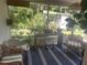 Cozy screened porch with wicker furniture, stylish decor, and a view of the lush backyard at 4718 Crystal Ave, Sarasota, FL 34231