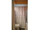 Cozy bathroom features a shower with a floral curtain, offering a private and refreshing experience at 7713 39Th N Ave, St Petersburg, FL 33709
