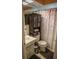 Well-appointed bathroom with a shower-tub combo and a practical shelving unit for optimal storage at 7713 39Th N Ave, St Petersburg, FL 33709