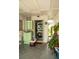 Practical laundry area with a stacked washer and dryer, enhanced by bright green cabinets and verdant plants at 7713 39Th N Ave, St Petersburg, FL 33709