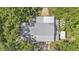 Overhead view of a roof on a home surrounded by lush trees and greenery at 1309 Joe Mcintosh Rd, Plant City, FL 33565
