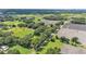 High up aerial view of property showcasing open fields, trees and home location at 1309 Joe Mcintosh Rd, Plant City, FL 33565