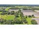 High up aerial shot of the property, showcasing the home, barn, and surrounding landscape at 1309 Joe Mcintosh Rd, Plant City, FL 33565