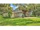 Exterior shot of barn with large metal structure, and overgrown grass at 1309 Joe Mcintosh Rd, Plant City, FL 33565